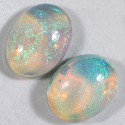 SOLID CRYSTAL OPALS Matching pair, 3D pattern. Bright green fire throughout